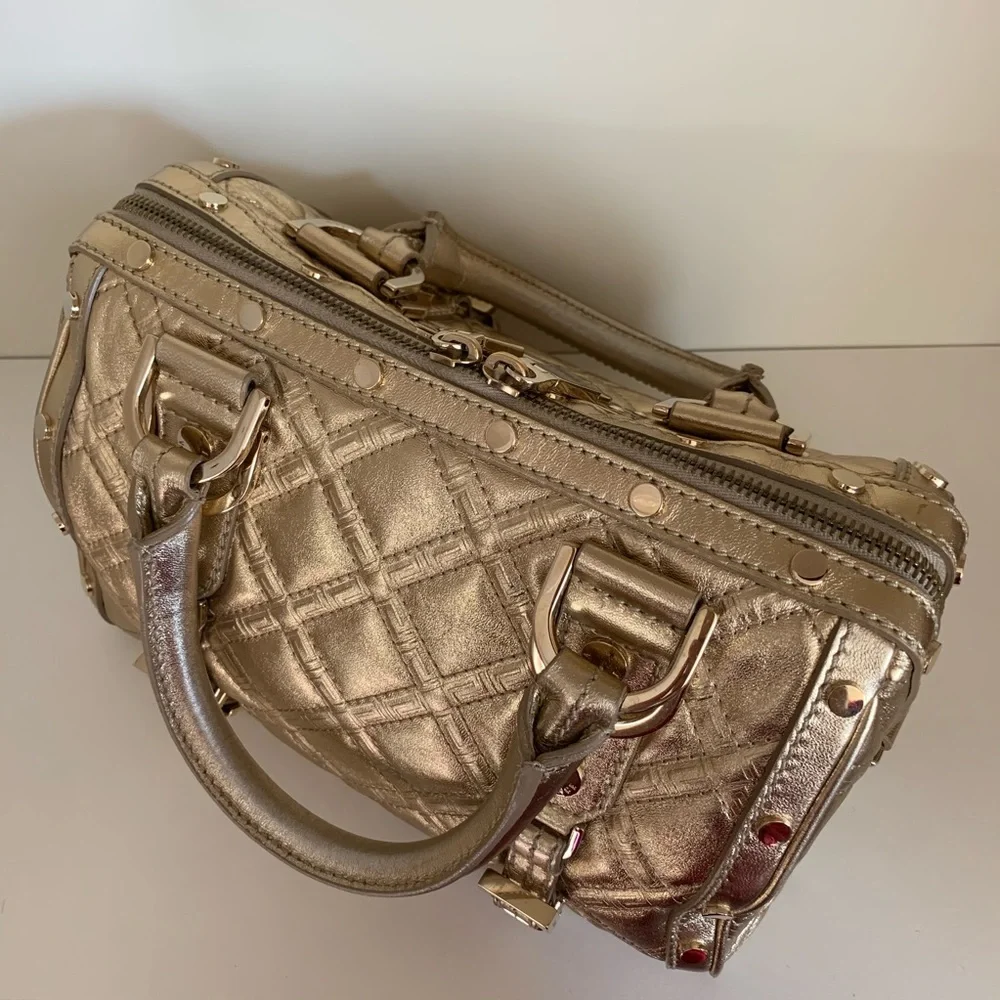 Hold Versace gold quilted handbag
